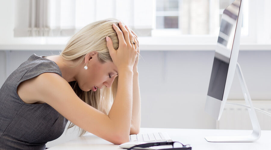 Overworked woman in front of computer
